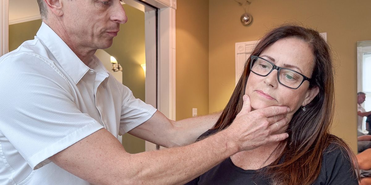 Mark assessing a patient's neck and jaw