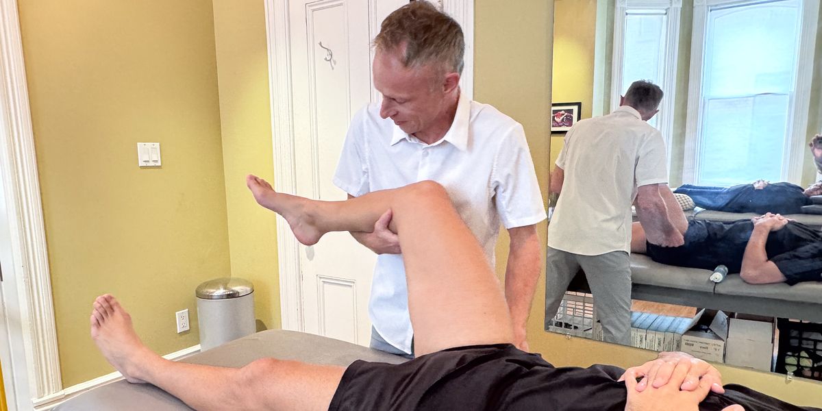 Mark moving a patient's hip and knee through rehab