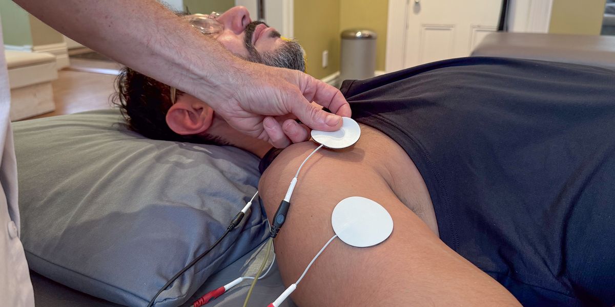Electrotherapy on a patient's shoulder